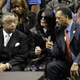 In this file photo Michael Jackson sits with the Reverends Jessie Jackson (R) and Al Sharpton (L) at the funeral of James Brown December 30 2006,